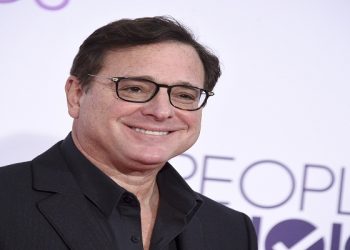 FILE - Bob Saget arrives at the People's Choice Awards at the Microsoft Theater on Wednesday, Jan. 18, 2017, in Los Angeles. Saget, a comedian and actor known for his role as a widower raising a trio of daughters in the sitcom “Full House,” has died, according to authorities in Florida, Sunday, Jan. 9, 2022. He was 65. (Photo by Jordan Strauss/Invision/AP, File)