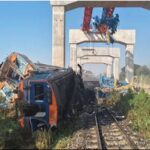 Crane falls on moving train