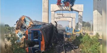 Crane falls on moving train