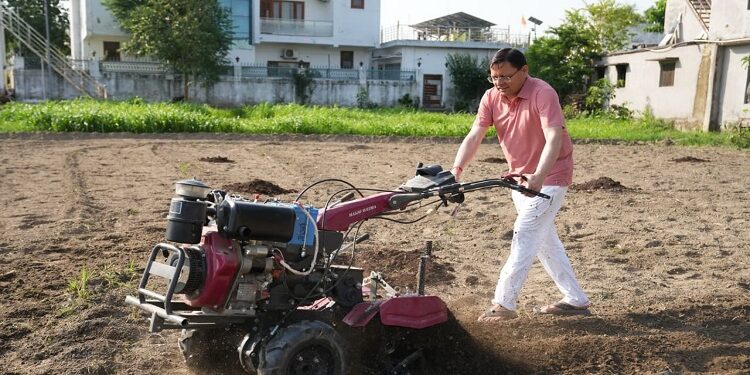 CM Dhami operated the tiller in the field
